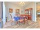 Elegant dining room featuring wood floors, a chandelier, and a formal dining set at 1624 Maximilian Dr, Wesley Chapel, FL 33543