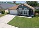Well-maintained one-story home with verdant lawn, neutral paint and two car garage at 1624 Maximilian Dr, Wesley Chapel, FL 33543