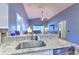 Bright kitchen featuring granite countertops, stainless steel sink, and modern appliances, open to the main living area at 1624 Maximilian Dr, Wesley Chapel, FL 33543