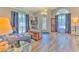Cozy living room with tile floors, blue curtains, and arched windows at 1624 Maximilian Dr, Wesley Chapel, FL 33543