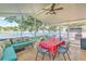 Enclosed patio featuring outdoor seating, dining set, and views of the lake at 1624 Maximilian Dr, Wesley Chapel, FL 33543