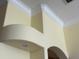 Unique architectural detail featuring layered crown molding and an arched alcove at 17127 Brown Rd, Odessa, FL 33556