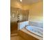 Bathroom featuring a large bathtub and glass enclosed shower area at 17127 Brown Rd, Odessa, FL 33556