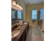 Bathroom featuring double sinks, granite countertops, and tile flooring at 17127 Brown Rd, Odessa, FL 33556