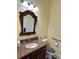 Bathroom featuring a granite countertop vanity and decorative mirror at 17127 Brown Rd, Odessa, FL 33556