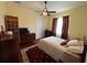 Cozy bedroom with ceiling fan, dresser, and comfortable bed with red accent rug at 17127 Brown Rd, Odessa, FL 33556
