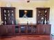 An elaborate built-in cabinet unit with display shelves, cabinets, and a large flat screen TV at 17127 Brown Rd, Odessa, FL 33556