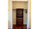 Walk-in closet with built-in shelving and hardwood floors at 17127 Brown Rd, Odessa, FL 33556