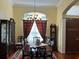 Elegant dining room featuring hardwood floors, a chandelier, and a classic china cabinet at 17127 Brown Rd, Odessa, FL 33556