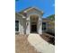 Elegant entryway with a double door, pendant light, and well-manicured landscaping at 17127 Brown Rd, Odessa, FL 33556