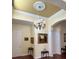 Warm entryway featuring a decorative ceiling medallion, chandelier, and rich hardwood floors at 17127 Brown Rd, Odessa, FL 33556