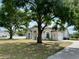 Charming single-story home with mature trees, well-maintained lawn, and attached two-car garage at 17127 Brown Rd, Odessa, FL 33556