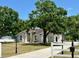 Charming single-story home with a well-manicured lawn, mature trees, and a long driveway at 17127 Brown Rd, Odessa, FL 33556