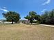 Lovely one-story home featuring a spacious front yard, mature trees, and a long driveway at 17127 Brown Rd, Odessa, FL 33556