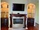 Elegant fireplace with decorative mantle and built-in shelving at 17127 Brown Rd, Odessa, FL 33556