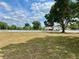 Expansive front yard with mature trees and a white picket fence lining the property at 17127 Brown Rd, Odessa, FL 33556
