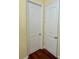 Hallway featuring white doors and wood floors at 17127 Brown Rd, Odessa, FL 33556