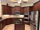 Spacious kitchen with stainless steel appliances, custom cabinetry and granite countertops at 17127 Brown Rd, Odessa, FL 33556