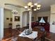 Open living area featuring hardwood floors, elegant furnishings, and a decorative chandelier at 17127 Brown Rd, Odessa, FL 33556