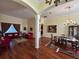 Inviting living area featuring hardwood floors, classic furnishings, and an archway to other rooms at 17127 Brown Rd, Odessa, FL 33556
