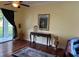 A comfortable living room features a dark sofa, wood floors, a table, and sliding glass door to the exterior at 17127 Brown Rd, Odessa, FL 33556