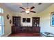 Living room featuring an elaborate built-in unit with display shelves, cabinets, and a large flat screen TV at 17127 Brown Rd, Odessa, FL 33556