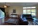 Comfortable living room featuring a dark sofa, wood floors, and a sliding glass door to the exterior at 17127 Brown Rd, Odessa, FL 33556