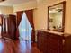 Spacious main bedroom features an armoire, dresser, and window with decorative curtains at 17127 Brown Rd, Odessa, FL 33556