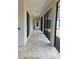 Enclosed patio with tile flooring, sliding glass doors, and views of the backyard at 17127 Brown Rd, Odessa, FL 33556