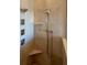 Shower with multiple heads, marble tiles, and built-in shelves at 17127 Brown Rd, Odessa, FL 33556
