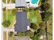 Aerial view of the property highlighting a well-maintained roof, spacious backyard, and surrounding lush greenery at 1751 Ashton Abbey Rd, Clearwater, FL 33755