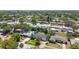 Overhead view of a residential area with lush green trees, well-maintained homes, and several swimming pools at 1751 Ashton Abbey Rd, Clearwater, FL 33755