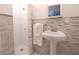 Charming bathroom showcasing a tiled shower with glass doors and a pedestal sink with stylish fixtures at 1751 Ashton Abbey Rd, Clearwater, FL 33755