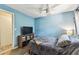 Light blue bedroom offers natural light, complemented by a ceiling fan, creating a soothing atmosphere at 1751 Ashton Abbey Rd, Clearwater, FL 33755