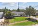 Charming home with lush front lawn, mature trees, and a welcoming facade in a desirable neighborhood at 1751 Ashton Abbey Rd, Clearwater, FL 33755