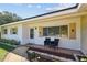 Close-up view of the front porch featuring tasteful decorations and ample seating space at 1751 Ashton Abbey Rd, Clearwater, FL 33755