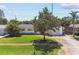 Well-maintained front yard with mature trees and green grass, providing curb appeal to the charming home at 1751 Ashton Abbey Rd, Clearwater, FL 33755