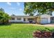 Charming single Gathering home featuring a lush green lawn and well-maintained landscaping at 1751 Ashton Abbey Rd, Clearwater, FL 33755