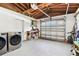 Functional garage with a washer and dryer, ample storage, and a work area for projects at 1751 Ashton Abbey Rd, Clearwater, FL 33755