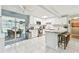 Bright kitchen with white cabinets, tiled backsplash, stainless appliances, and a breakfast bar at 1751 Ashton Abbey Rd, Clearwater, FL 33755