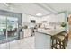 Bright kitchen featuring white cabinets, tiled backsplash, stainless appliances, and a breakfast bar at 1751 Ashton Abbey Rd, Clearwater, FL 33755