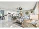 Open-concept living space with modern kitchen, island seating, and comfortable living room furniture at 1751 Ashton Abbey Rd, Clearwater, FL 33755
