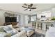 Cozy living room and open kitchen concept with white cabinets and an eat-in bar at 1751 Ashton Abbey Rd, Clearwater, FL 33755