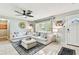 Cozy living room with large sectional sofa, stylish area rug, and plenty of natural light from the window at 1751 Ashton Abbey Rd, Clearwater, FL 33755