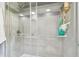 Modern shower featuring glass doors and stylish gray tile accents at 1751 Ashton Abbey Rd, Clearwater, FL 33755