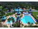 Aerial view of the community pool, clubhouse, sports courts, and beautiful green landscaping at 19116 Nature Palm Ln, Tampa, FL 33647