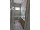 Tiled bathroom featuring a vanity, toilet, and tub with shower at 19116 Nature Palm Ln, Tampa, FL 33647
