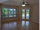 Bedroom with lanai access and a ceiling fan at 19116 Nature Palm Ln, Tampa, FL 33647
