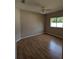 Bedroom featuring hardwood floors, a ceiling fan, and a bright window view at 19116 Nature Palm Ln, Tampa, FL 33647