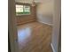 Bright bedroom featuring a window and hardwood floors at 19116 Nature Palm Ln, Tampa, FL 33647